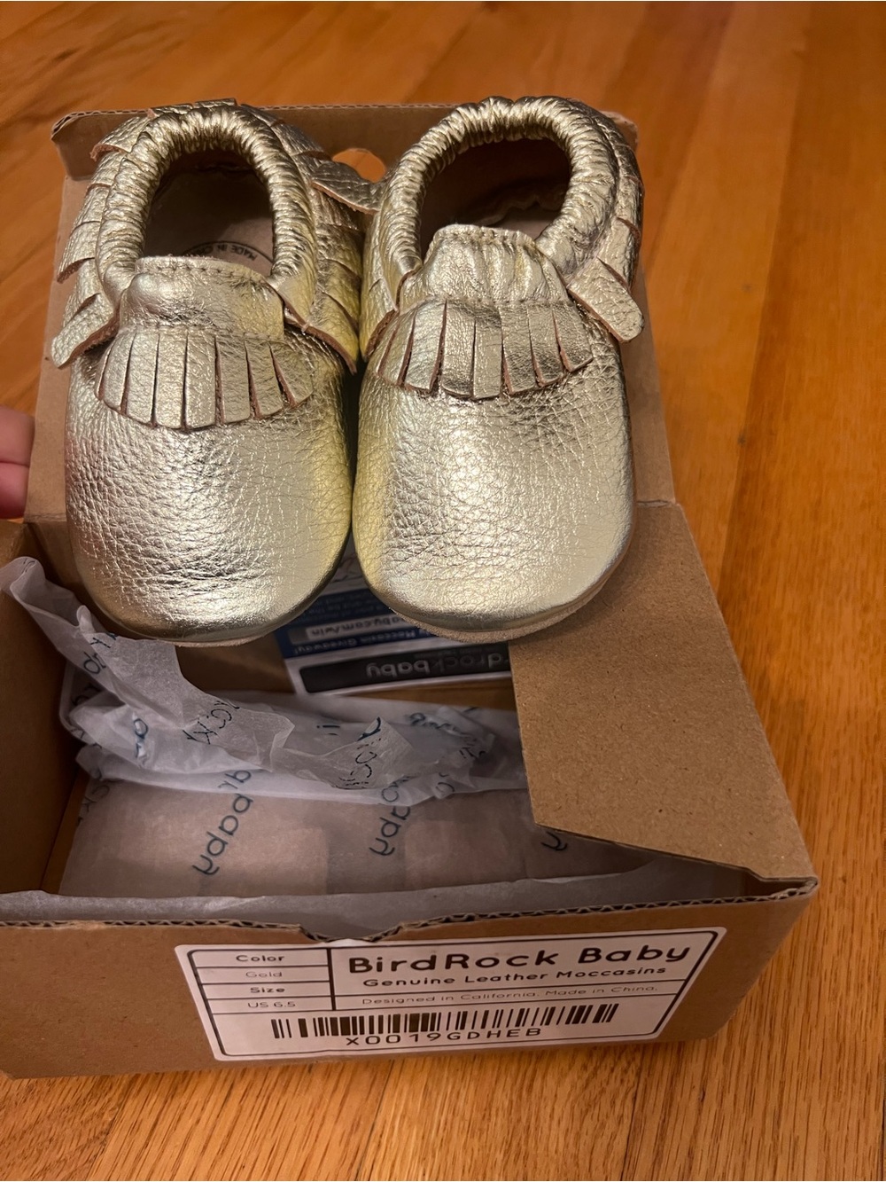 BirdRock Baby genuine leather moccasins feature a shiny gold shoes